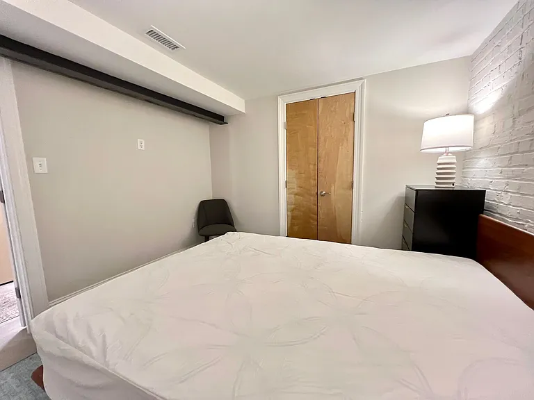 Secondary bedroom featuring queen Sleep Number bed with dual controls.
