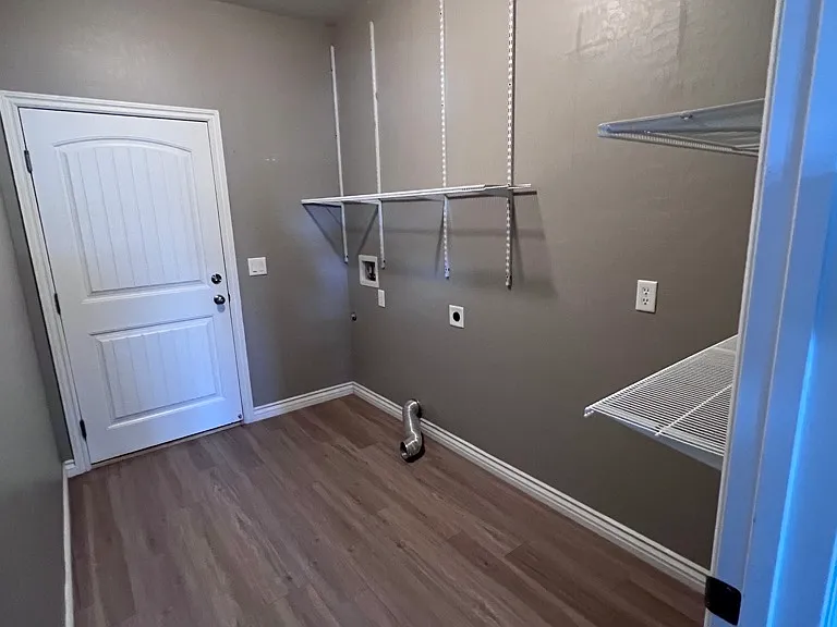 Spacious laundry room with shelves.