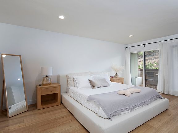 Primary bedroom with king size bed, en suite bathroom, desk area. New furnishings! Embrace the California Coastal Lifestyle.
