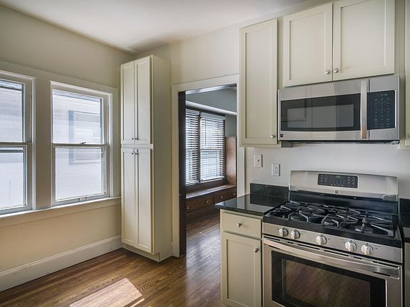 Recently renovated kitchen with new cabinets, dishwasher, refrigerator, stove, microwave and sink.