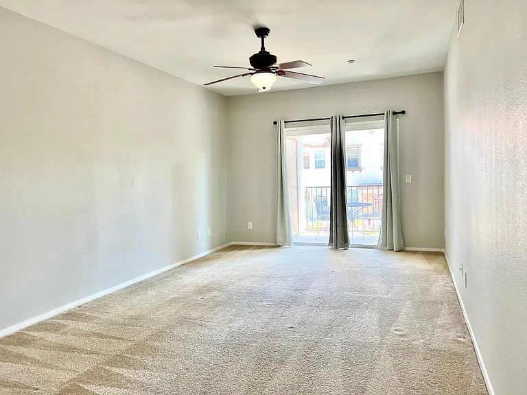a big size primary bedroom with a patio door, which connects to a private balcony