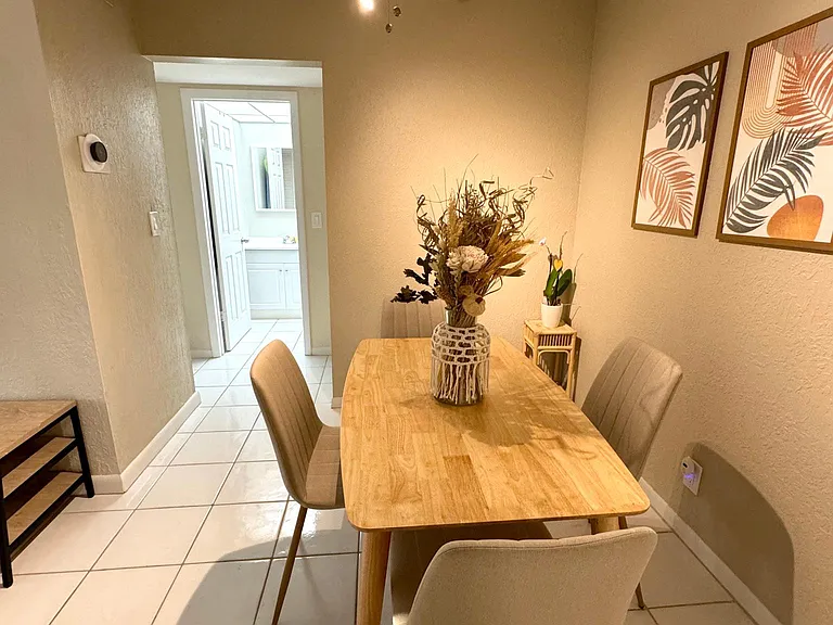 Lengthwise dining room view into second bathroom