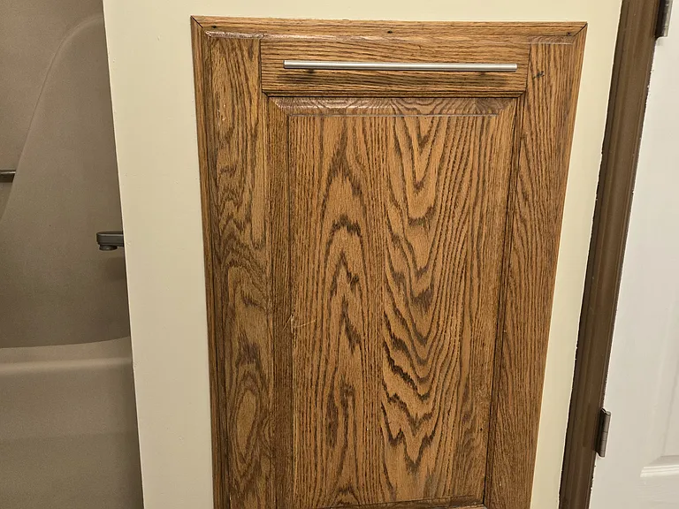 Builtin laundry hamper in downstairs bathroom