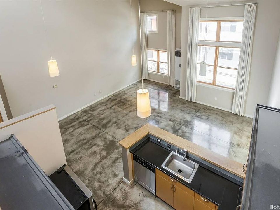 View down at kitchen and living room from the master bedroom