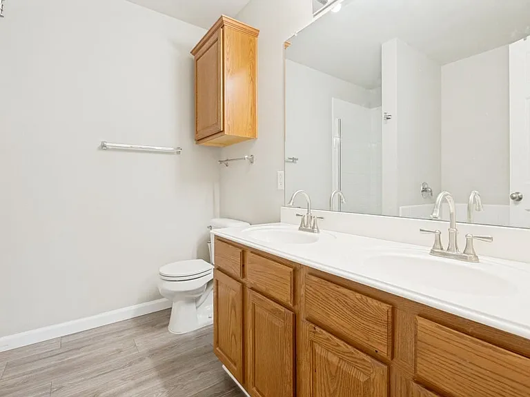 Full ensuite bathroom with two separate sinks, shower with glass door and soaking tub.