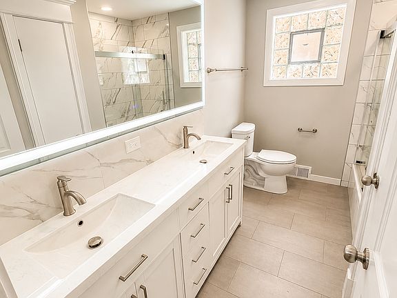 Dual sinks and lighted anti- fog mirror.