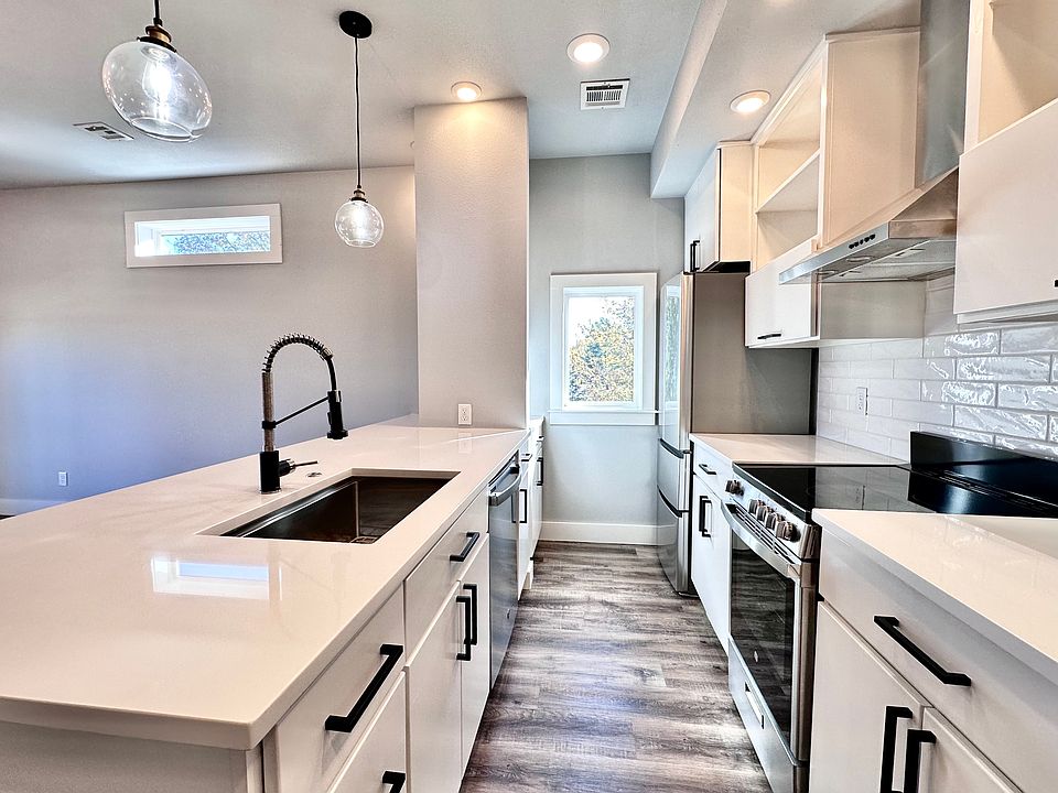 The kitchen features SS appliances, quartz countertops, premium finishes, and a window for bright natural light. Call or text for a tour today!