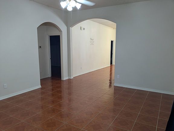 Living Room opening into the dining room, bedrooms 2&3, as well as the shared bathroom.