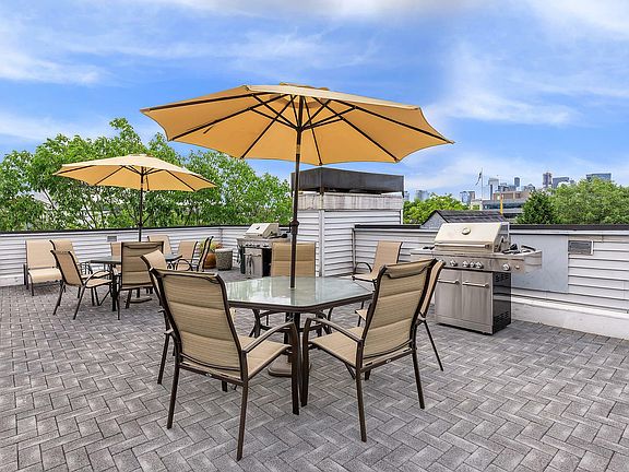 Enjoy al fresco dining with skyline views on this modern rooftop patio.