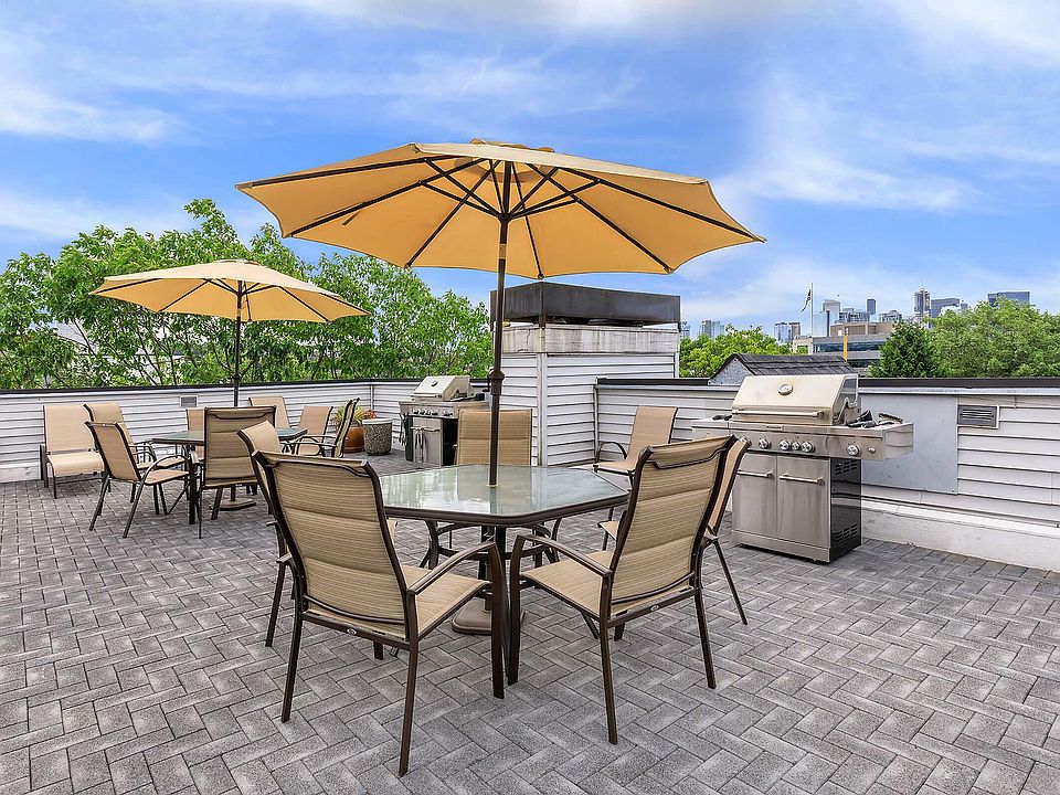 Enjoy al fresco dining with skyline views on this modern rooftop patio.