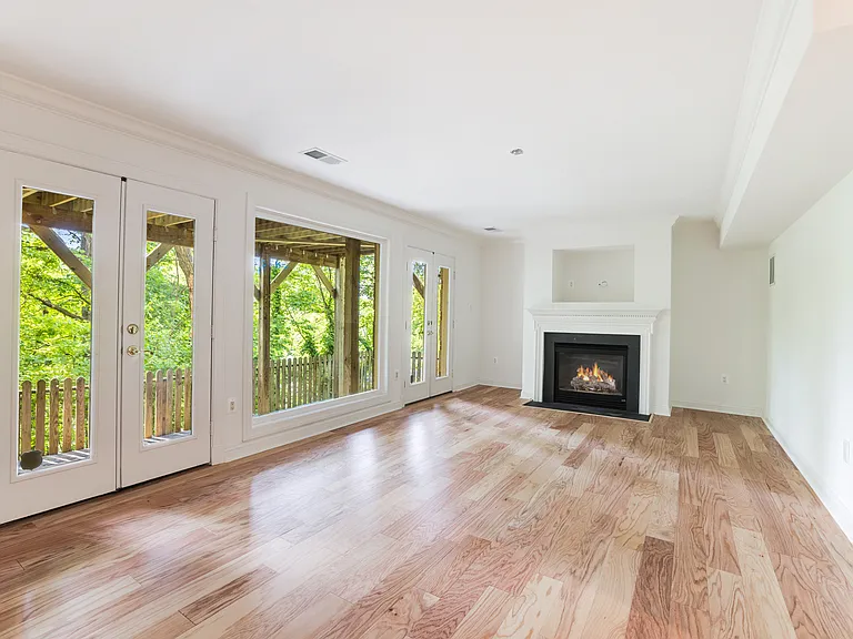 Ground level family room with French doors leading to the stone patio
