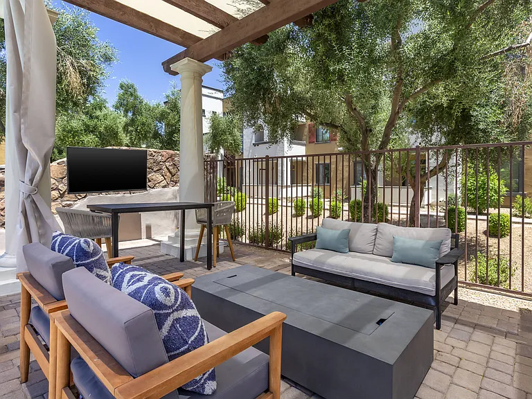 Enjoy our inviting patio furnished with comfy couches and a convenient table for your relaxation