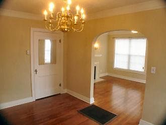 Dining Room with large closet adjoining. Note: The grate is not an operative furnace! Unit has central heat and air conditioning.