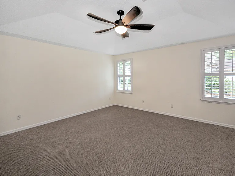 Primary suite bedroom with raised ceiling
