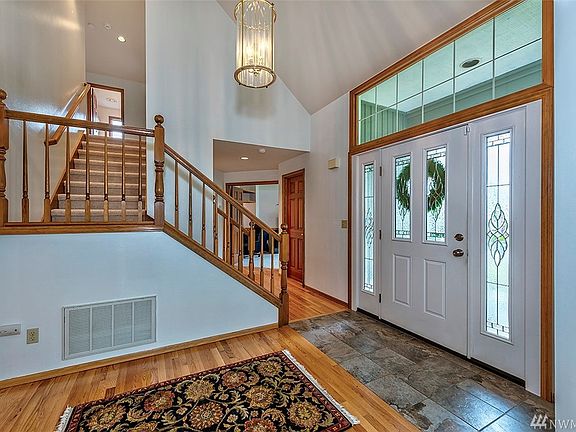 Vaulted ceiling for this airy entrance. Coat closet on the left after the staircase.
