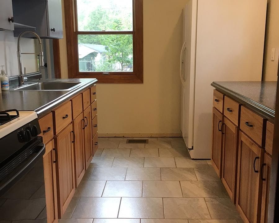 Fully remodeled kitchen with tile floor, beautiful cabinets