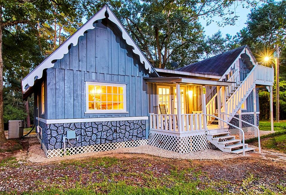 This charming one bedroom home is so much more than that! With an extra loft area at the top of the stairs, covered back porch, screened in patio/sunroom in the front, and an additional guest suite across the lawn, it's the house that keeps on giving