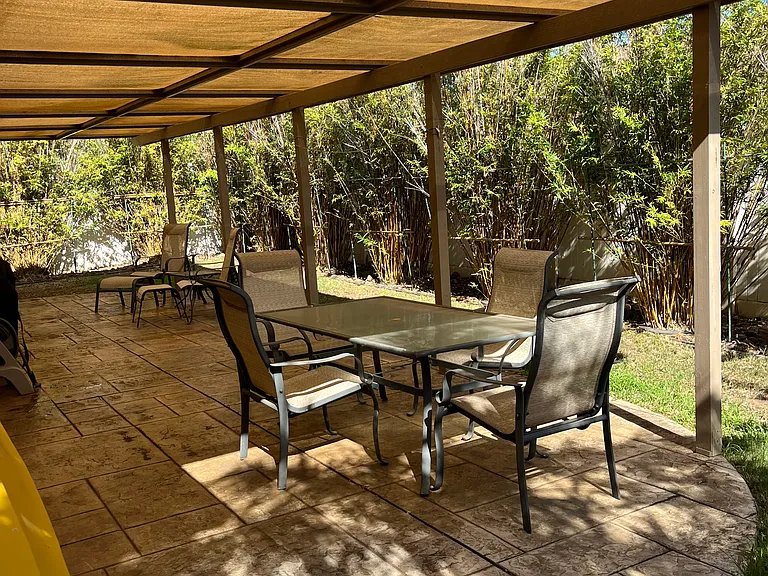 Outdoor covered lanai with patio furniture