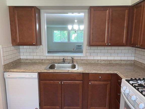 There's a cutout over the sink overlooking a large living room/dining area
