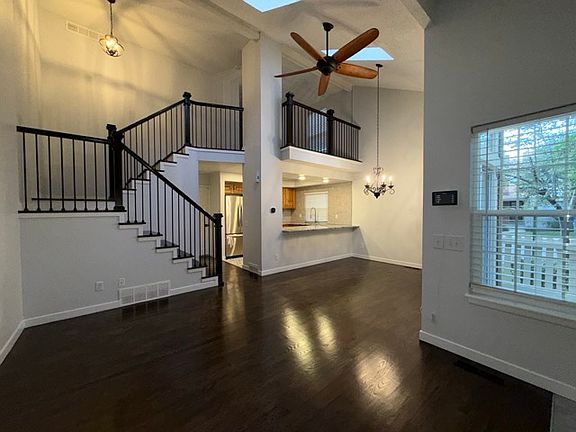 Spacious living room with vaulted ceilings and skylights