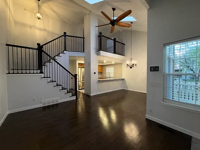 Spacious living room with vaulted ceilings and skylights