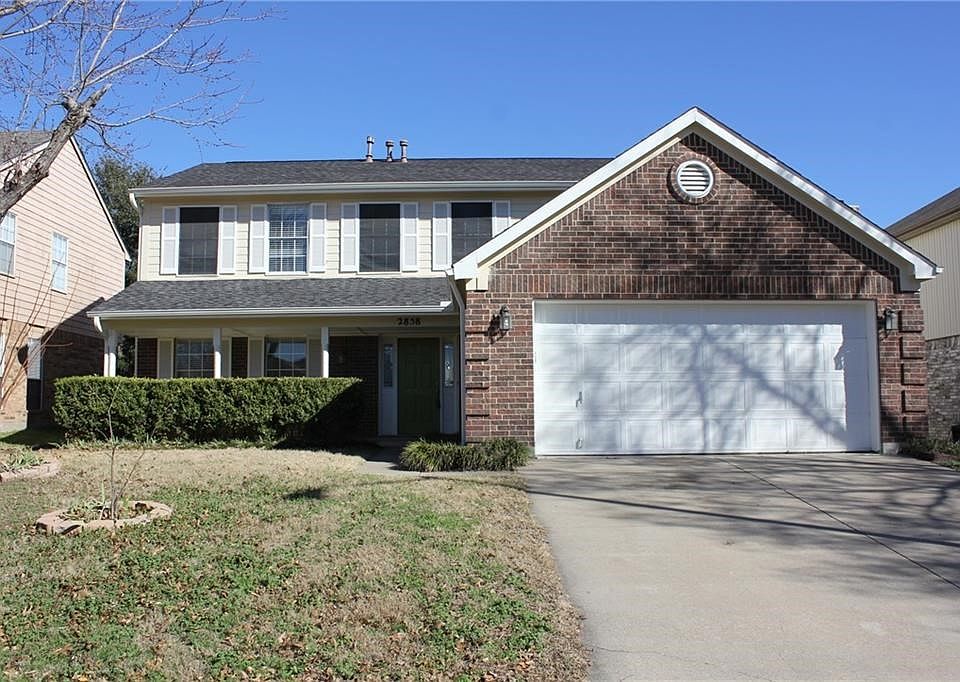 Charming front elevation with sprawling front porch, established landscaping, solar screens, fresh exterior paint and new gutters.