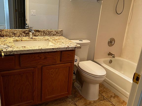 guest bath with tub and shower. new flooring and granite counter, fixtures