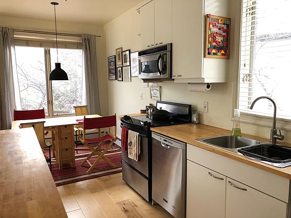 kitchen and dining area; fridge is to the right of the sink.