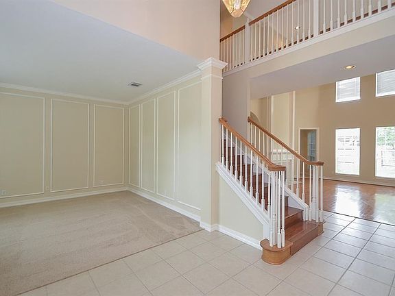 Formal living room has new paint and new carpeting. Extensive molding creates a dramatic effect.