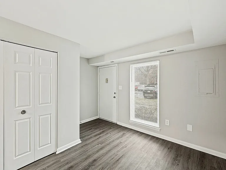Step into luxury with this welcoming entryway featuring sleek flooring and ample natural light.