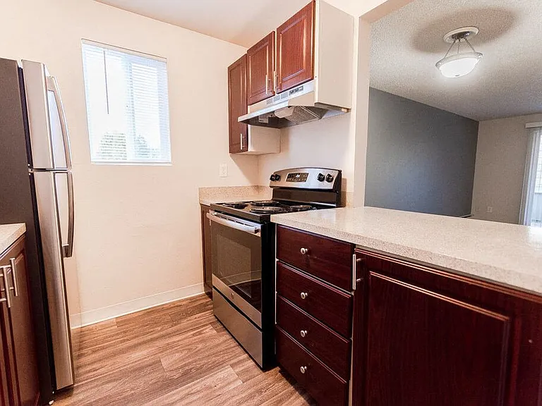 Lakewood Apartments - Bellmary Park Apartments - Kitchen, Living Room, and Deck