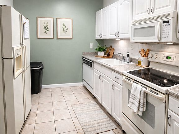 Apartment Kitchen - this image is for inspiration purposes only, and has been staged with AI. The apartment is unfurnished.