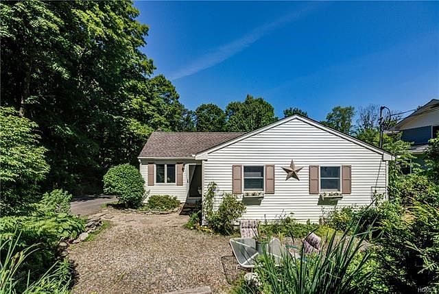 Front of home with perennial gardens galore.  New roof on home and rear dwelling.  Front sitting area and new stone pathway to entrance of home!