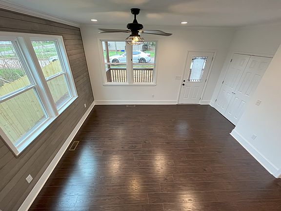 Living room from stairway. Double doors is a front closet.