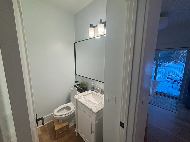 Guest bathroom near kitchen and front door.