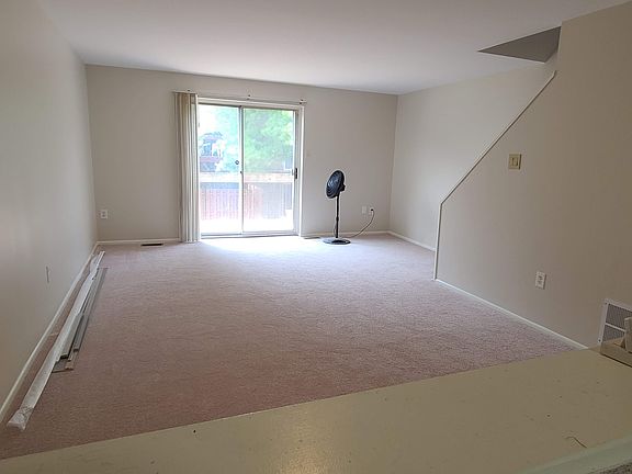 Spacious living room on main level with access to balcony.