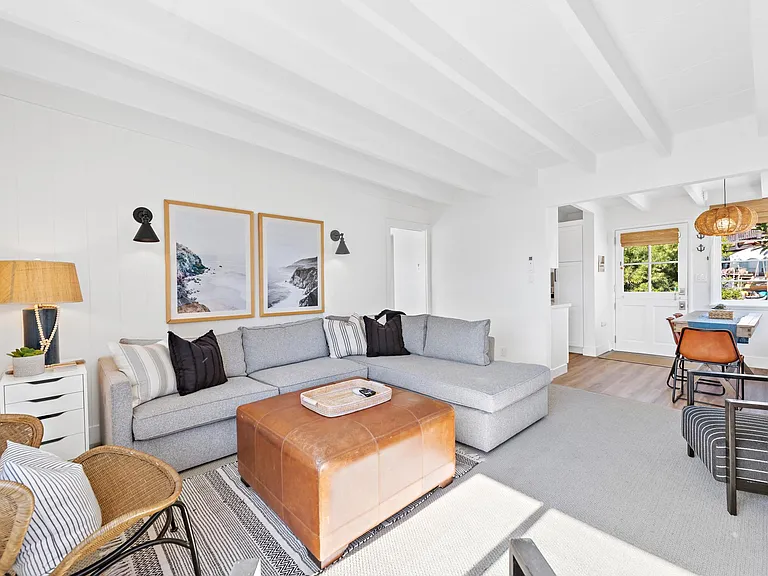 Light and bright coastal style living room. Pocket door separates living room from bedroom