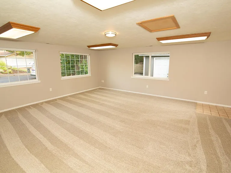 Converted garage makes an almost 450 sqft extra bonus room. New blinds have been installed. Separate door enters to the side yard.