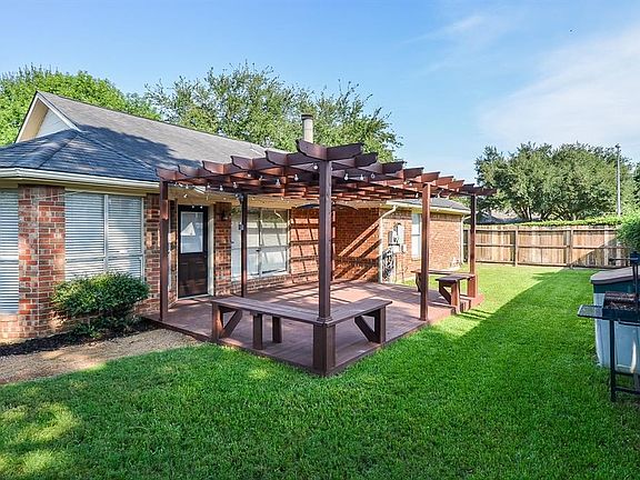 Enjoy your backyard with the arbor and deck with additional seating.
