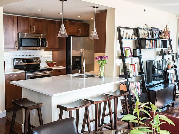 Open, renovated kitchen with quartz counters, stainless steel appliances