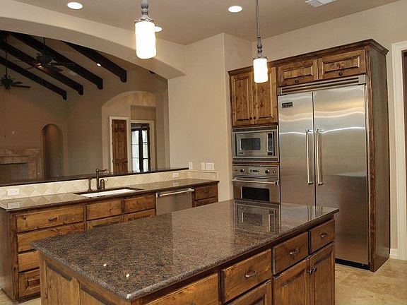 Viking appliances, granite slabs, and travertine