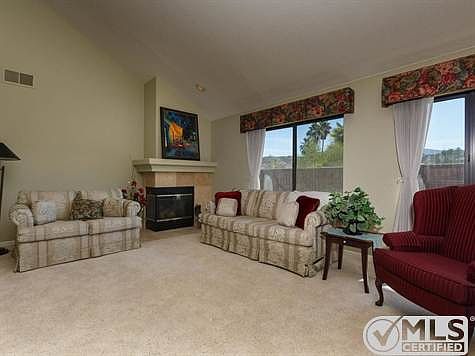 Spacious Living Room with upgraded carpet and fireplace.