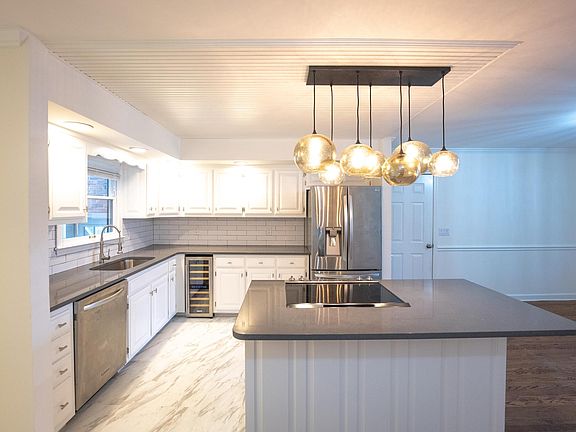 Updated kitchen with quartz counters, lots of storage and stainless appliances