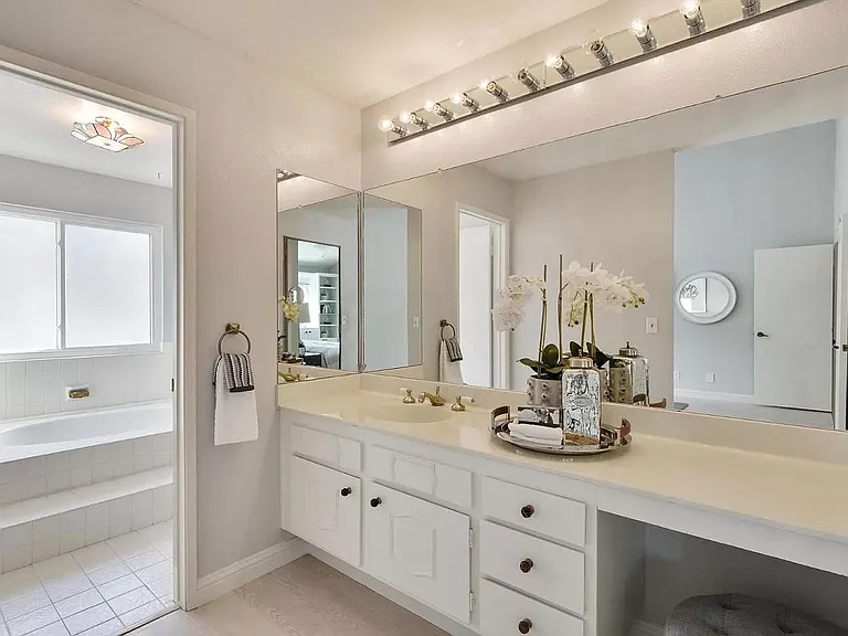 Master Vanity area with single sink. All white.