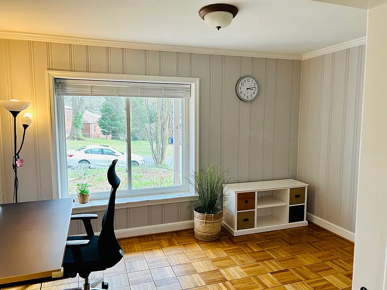 A fourth bedroom/den is filled with sunlight and opens directly to the living room. Currently set up as a home office. Also perfect as a kid's room, formal dining room, or family room.