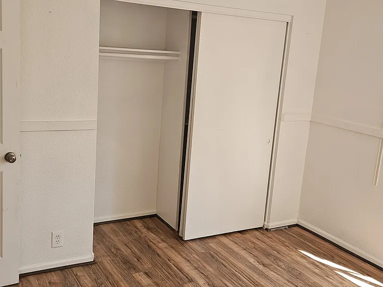Lower-level bedroom featuring updated flooring, a built-in closet, and a comfortable, functional layout.