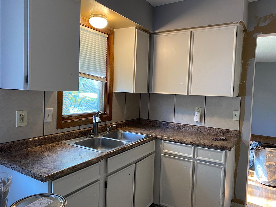 Kitchen with lots of natural light. There are two windows in the kitchen with a small seating area