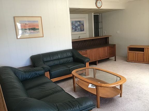 Teak and leather furniture .