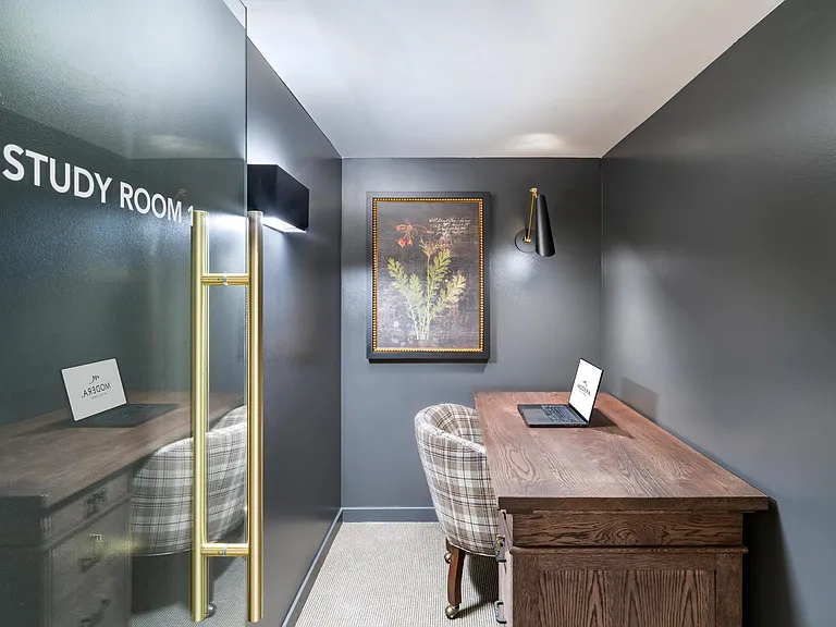 A private study room at Modera University Park, offering a quiet, design-forward setting for focused work and productivity.