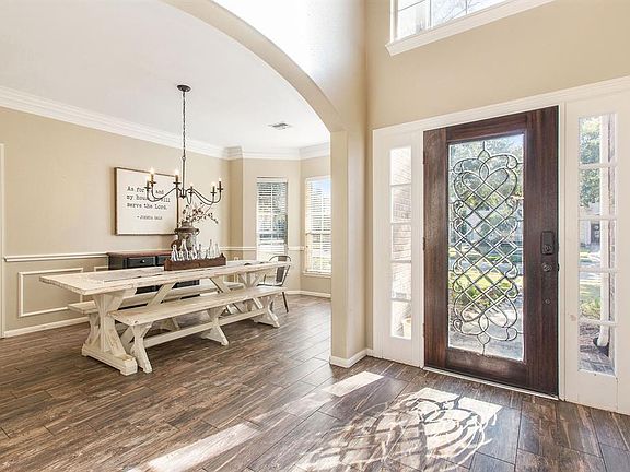 A bright and airy entryway welcomes you into this warm home! The light flows in from the beautiful leaded glass door, sidelights and large picture window above the entry door!